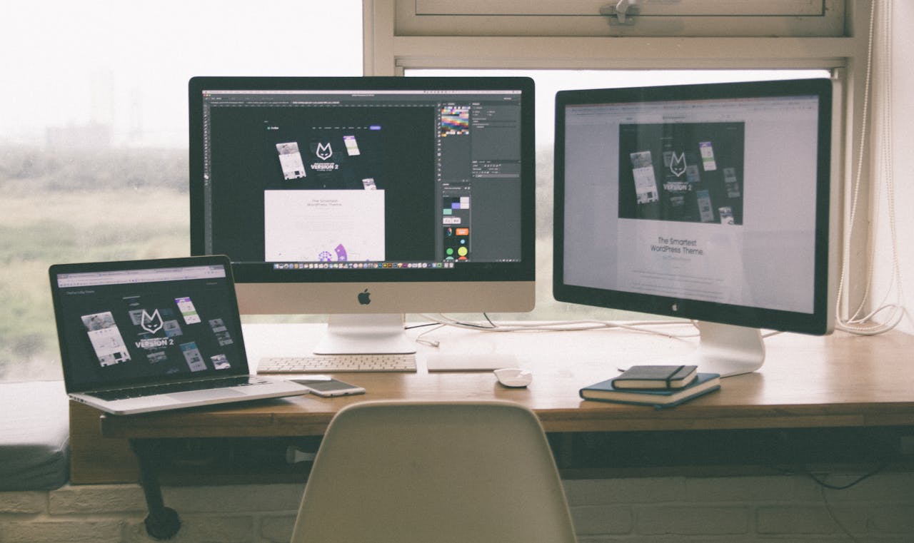 services-04 Stylish and efficient workspace with multiple monitors, laptop, and smartphone, showcasing a web design project.